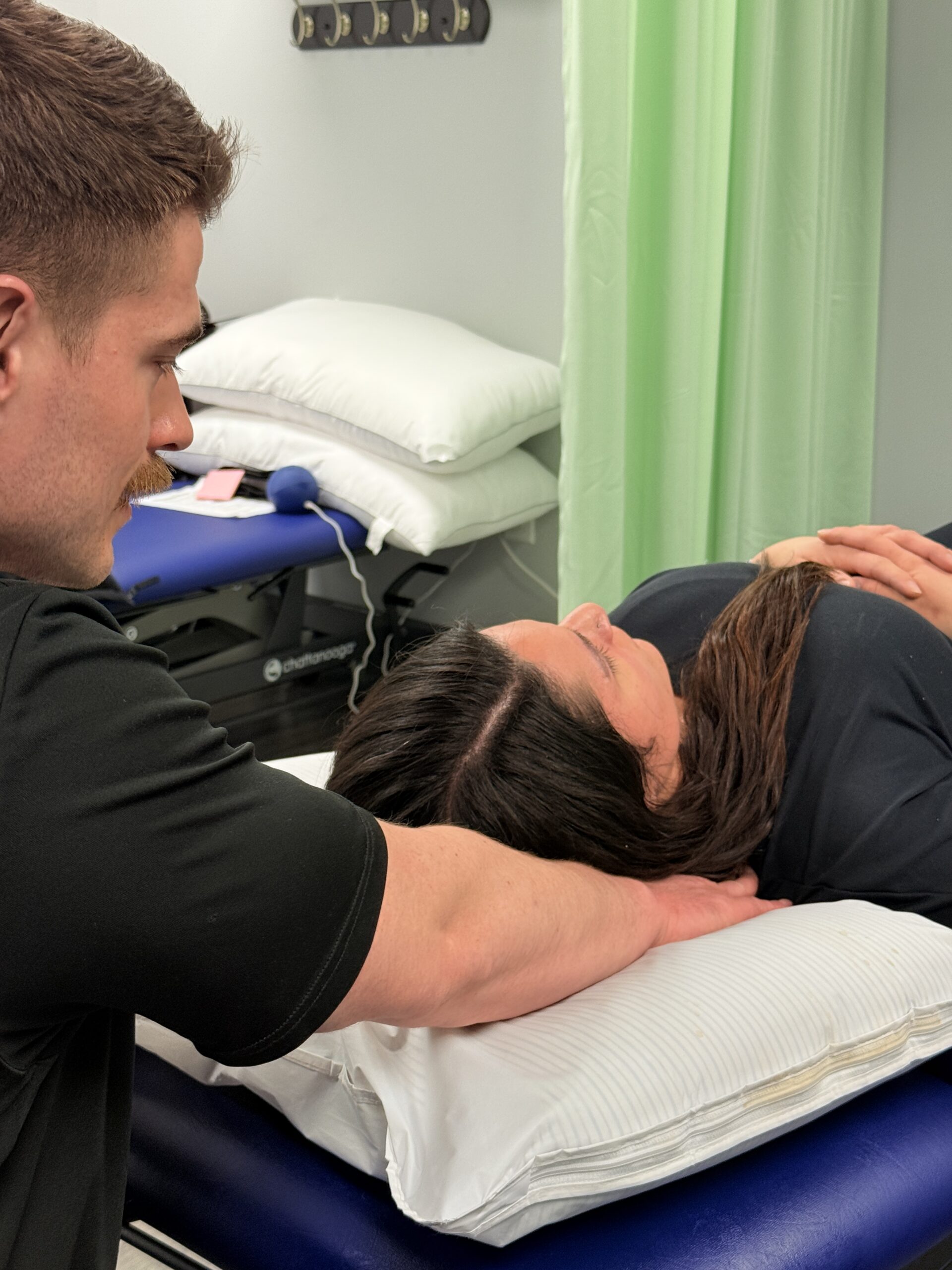 Athletic Therapist measuring the craniovertebral angle (forward head posture) on a patient.
